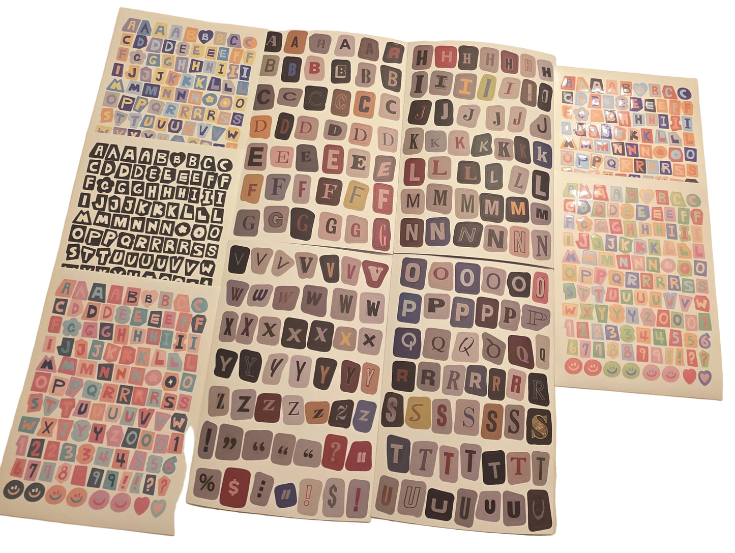Collection of colorful letter stickers on a beige surface