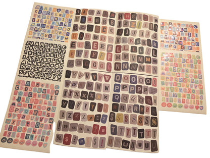 Collection of colorful letter stickers on a beige surface