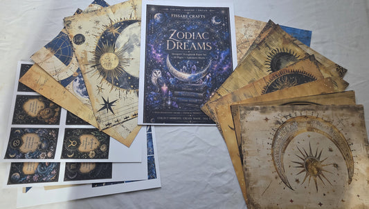 Zodiac Dreams themed scrapbook paper on a textured surface.