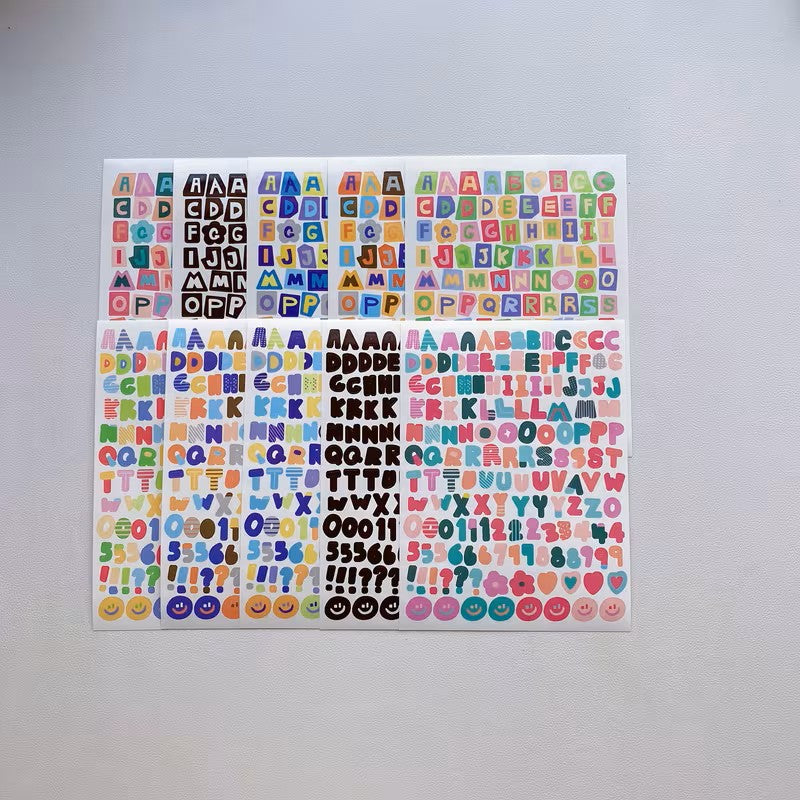 Sheet of colorful alphabet and number stickers on a gray background