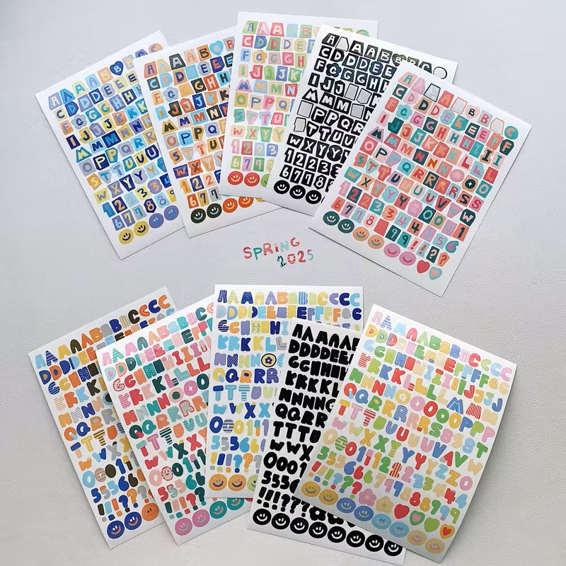 Collection of colorful letter and number stickers on a gray background