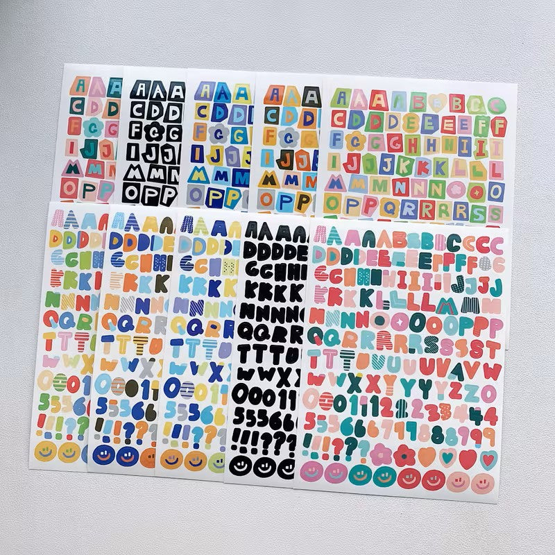 Sheet of colorful alphabet and number stickers on a gray background